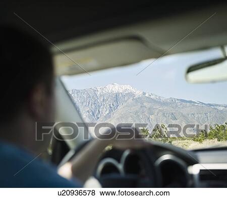 USA, California, Palm Springs, Coachella Valley, San Gorgonio Pass, Close up of man inside car View Large Photo Image Stock Photo - USA, California, Palm Springs, Coachella Valley, San Gorgonio Pass, Close up of man inside car. Fotosearch
