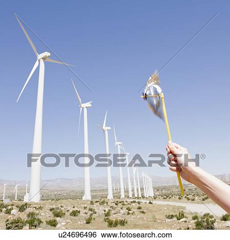 USA, California, Palm Springs, Coachella Valley, San Gorgonio Pass, Woman's hand holding pinwheel against blue sky and wind turbines View Large Photo Image Stock Photograph - USA, California, Palm Springs, Coachella Valley, San Gorgonio Pass, Woman's hand holding pinwheel against blue sky and wind turbines. Fotosearch