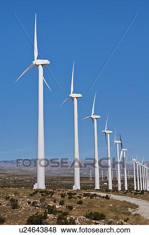 Stock Photo - USA, California, Palm Springs, Wind turbines against blue sky. Fotosearch