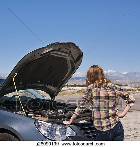 USA, California, Palm Springs, Woman standing in front of broken car in desert View Large Photo Image Stock Photo - USA, California, Palm Springs, Woman standing in front of broken car in desert. Fotosearch