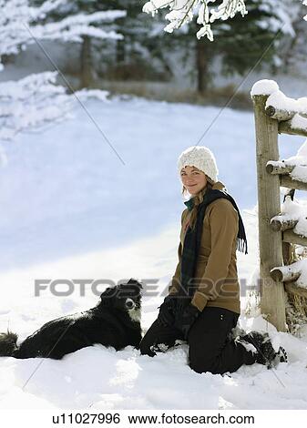 USA, Colorado, portrait of young woman with dog in snow View Large Photo Image Stock Photograph - USA, Colorado, portrait of young woman with dog in snow. Fotosearch