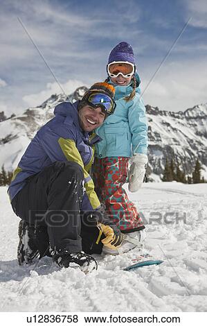 USA, Colorado, Telluride, Father and daughter (10-11) posing with snowboards in winter scenery View Large Photo Image Stock Photo - USA, Colorado, Telluride, Father and daughter (10-11) posing with snowboards in winter scenery. Fotosearch