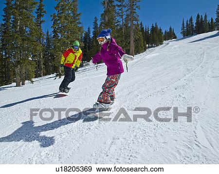 USA, Colorado, Telluride, Father and daughter (10-11) snowboarding View Large Photo Image Stock Photo - USA, Colorado, Telluride, Father and daughter (10-11) snowboarding . Fotosearch