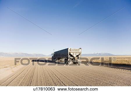 Stock Image - USA, Colorado, truck on dirt road. Fotosearch