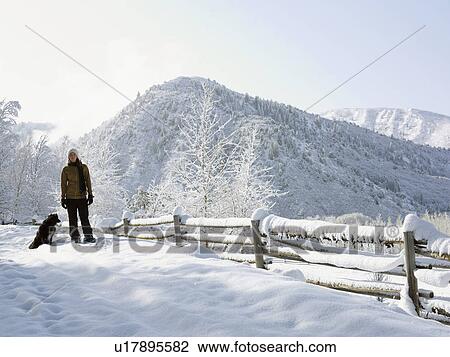 USA, Colorado, woman and dog in snowy ranch View Large Photo Image Stock Image - USA, Colorado, woman and dog in snowy ranch. Fotosearch