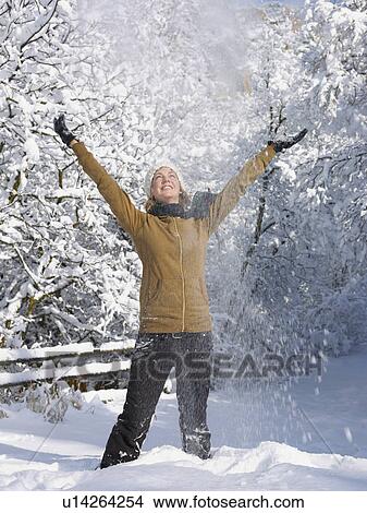 USA, Colorado, young woman throwing snow in air View Large Photo Image Picture - USA, Colorado, young woman throwing snow in air. Fotosearch