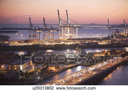 Stock Image - USA, Florida, Miami, Commercial dock at dusk. Fotosearch