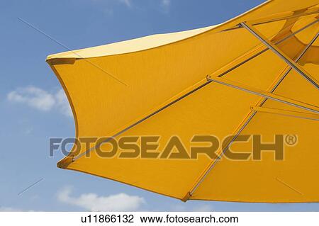 Stock Image - USA, Florida, Miami, Yellow sunshade against blue sky. Fotosearch
