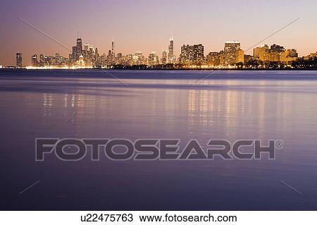 Stock Image - USA, Illinois, Chicago, City skyline over Lake Michigan. Fotosearch