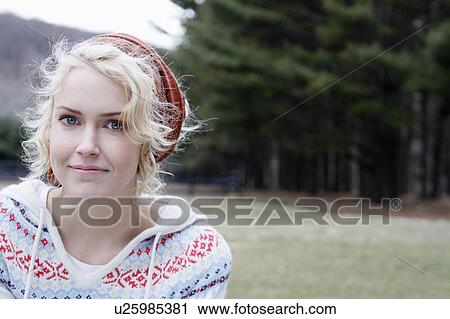Stock Image - USA, New Jersey, Califon, Young woman looking at camera and smiling. Fotosearch