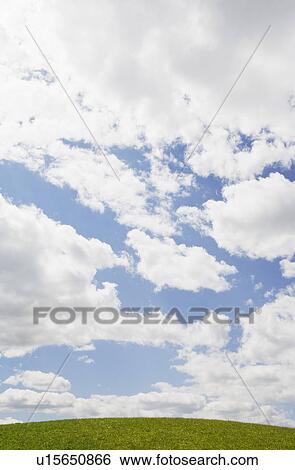 Stock Photograph - USA, New Jersey, clouds over green field. Fotosearch
