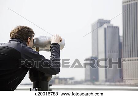USA, New York City, Manhattan, man looking at skyline through telescope View Large Photo Image Stock Photo - USA, New York City, Manhattan, man looking at skyline through telescope. Fotosearch