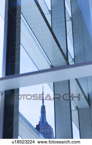 Picture - USA, New York, New York City, Empire State Building seen behind window frame. Fotosearch