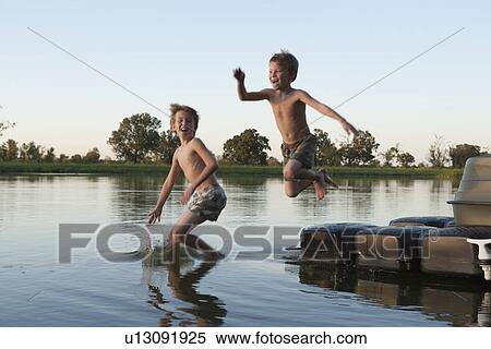USA, Texas, Texarkana, Two boys (8-9) jumping into lake View Large Photo Image Stock Photography - USA, Texas, Texarkana, Two boys (8-9) jumping into lake. Fotosearch