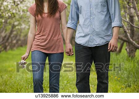 USA, Utah, Provo, Young couple walking through orchard View Large Photo Image Stock Photograph - USA, Utah, Provo, Young couple walking through orchard. Fotosearch