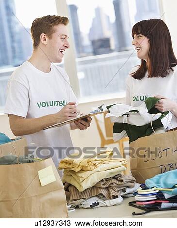 Volunteers organizing clothing drive View Large Photo Image Stock Image - Volunteers organizing clothing drive. Fotosearch