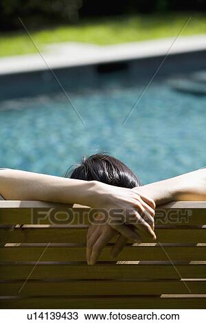Stock Image - Woman relaxing in chair. Fotosearch