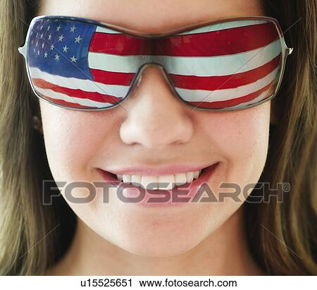 Woman wearing sunglasses reflecting US flag View Large Photo Image Stock Image - Woman wearing sunglasses reflecting US flag. Fotosearch
