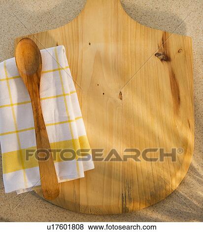 Stock Photo - Wooden chopping board, spoon ad checked napkin. Fotosearch
