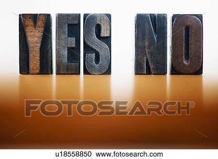 Stock Image - Wooden letter blocks spelling 'yes' and 'no', studio shot. Fotosearch