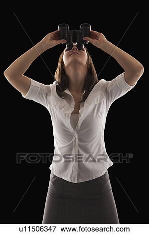 Young attractive businesswoman looking through binoculars View Large Photo Image Stock Photo - Young attractive businesswoman looking through binoculars. Fotosearch