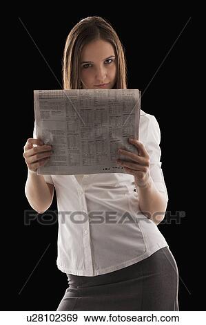 Young attractive businesswoman peeking from behind financial newspaper View Large Photo Image Stock Photo - Young attractive businesswoman peeking from behind financial newspaper. Fotosearch