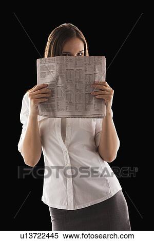 Young attractive businesswoman peeking from behind financial newspaper View Large Photo Image Stock Photography - Young attractive businesswoman peeking from behind financial newspaper. Fotosearch