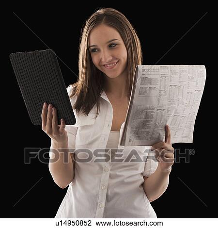 Young attractive businesswoman comparing financial results with financial column in newspaper View Large Photo Image Stock Image - Young attractive businesswoman comparing financial results with financial column in newspaper. Fotosearch