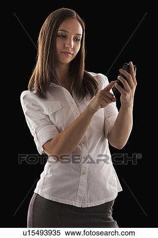 Stock Photography - Young attractive businesswoman text messaging. Fotosearch