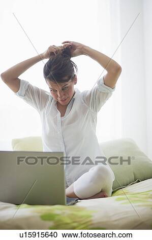 Stock Image - Young attractive woman using laptop. Fotosearch