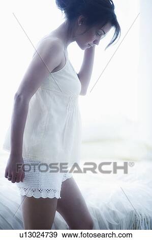 Stock Photo - Young attractive woman wearing laced nightwear. Fotosearch