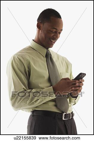 Stock Photo - Young businessman using mobile phone . Fotosearch