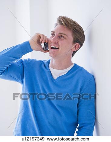 Stock Photo - Young man talking on mobile phone. Fotosearch