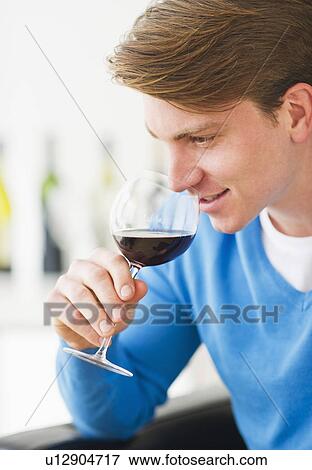 Stock Photo - Young man tasting red wine. Fotosearch