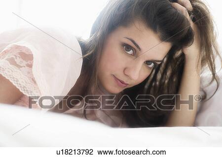 Stock Image - Young woman daydreaming . Fotosearch
