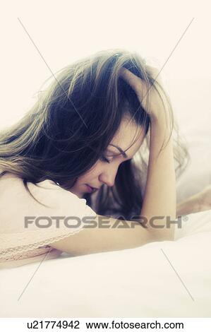 Stock Image - Young woman daydreaming . Fotosearch