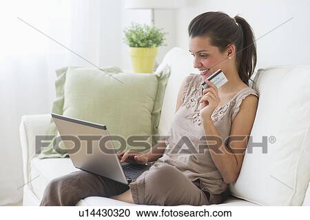 Young woman online shopping View Large Photo Image Stock Image - Young woman online shopping . Fotosearch