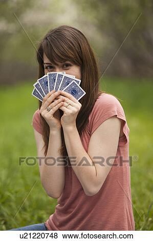 Young woman playing cards in orchard View Large Photo Image Stock Photo - Young woman playing cards in orchard. Fotosearch
