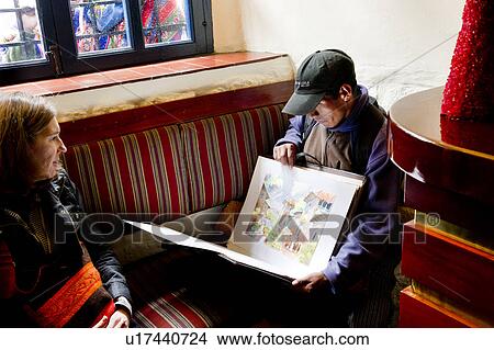 Artist showing his paintings to a woman, Cuzco, Peru View Large Photo Image Picture - Artist showing his paintings to a woman, Cuzco, Peru. Fotosearch
