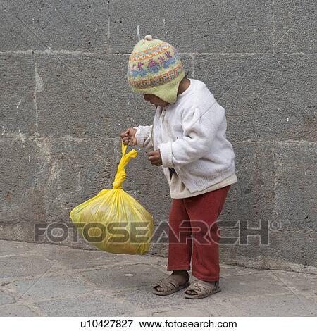 Stock Photo - Boy playing with a plastic bag, Sacred Valley, Cusco Region, Peru. Fotosearch