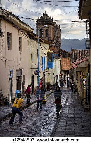 Children playing volleyball on a wet street, Cuzco, Peru View Large Photo Image Stock Photo - Children playing volleyball on a wet street, Cuzco, Peru. Fotosearch