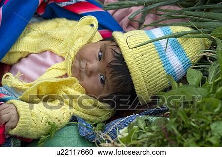 Close-up of a baby lying at a market stall at Sunday market, Pisac, Cuzco, Peru View Large Photo Image Stock Image - Close-up of a baby lying at a market stall at Sunday market, Pisac, Cuzco, Peru. Fotosearch
