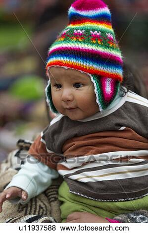 Close-up of a baby wearing a knit hat, Plaza Regocijo, Cuzco, Peru View Large Photo Image Stock Photo - Close-up of a baby wearing a knit hat, Plaza Regocijo, Cuzco, Peru. Fotosearch