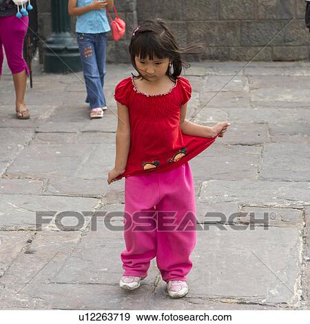 Stock Photo - Close-up of a girl pulling her top, Historic Centre of Lima, Lima, Peru. Fotosearch