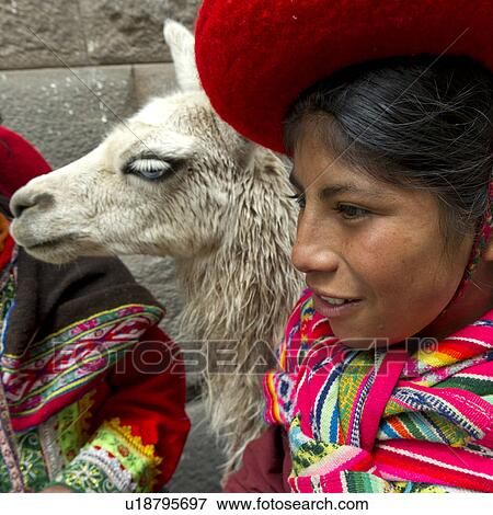 Stock Photo - Close-up of a girl with a llama (Lama glama), Cuzco, Peru. Fotosearch