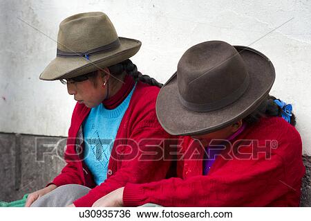 Stock Photograph - Close-up of two women sitting together, Mercado Central, Cuzco, Peru. Fotosearch