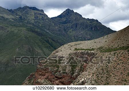 Stock Image - Clouds over a mountain range, Sacred Valley, Cusco Region, Peru. Fotosearch