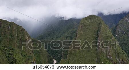 Clouds over mountains at The Lost City of The Incas, Machu Picchu, Cusco Region, Peru View Large Photo Image Stock Image - Clouds over mountains at The Lost City of The Incas, Machu Picchu, Cusco Region, Peru. Fotosearch