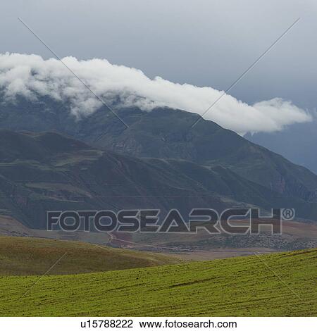 Stock Image - Clouds over mountains, Sacred Valley, Cusco Region, Peru. Fotosearch