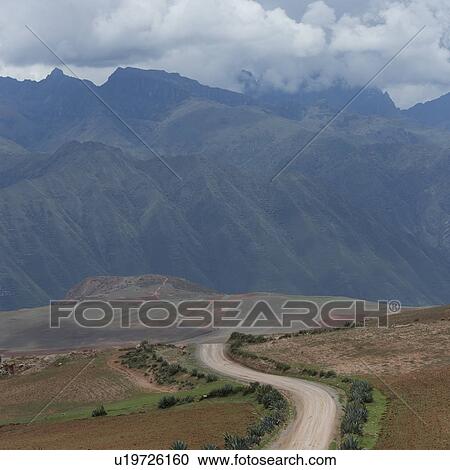 Dirt road passing through a landscape with a mountain range in the background, Sacred Valley, Cusco Region, Peru View Large Photo Image Stock Image - Dirt road passing through a landscape with a mountain range in the background, Sacred Valley, Cusco Region, Peru. Fotosearch